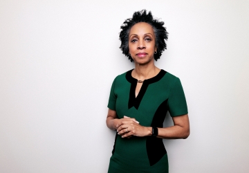 Portrait of Nina Shaw wearing a green and black dress