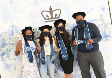 Members of the Class of 2021 pose in front of an illustration of campus