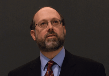 Man with beard in glasses and tie and jacket