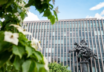 Flowers in bloom in front of Jerome Greene Hall