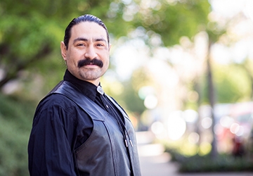 Man in a black shirt and black vest