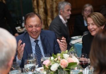 Man in a suit at a dinner event 