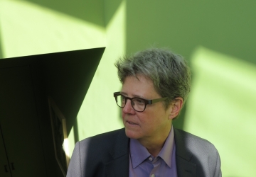 Woman in glasses, lavender blouse and blue jacket