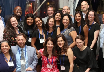 A group of about 20 people posing together