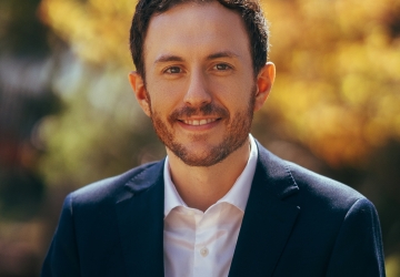 Bearded man in white shirt, dark suit jacket