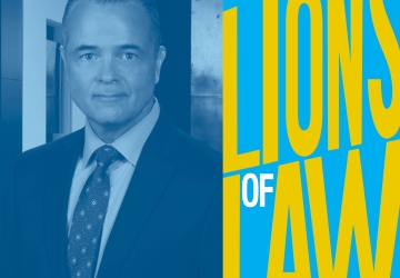 Man in tie and Lions of Law logo