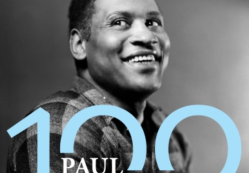 Black and white photo of Paul Robeson with text that says Paul Robeson 100