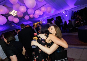 Women hugging in party tent