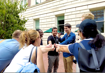 Students touch hands together during Orientation 2023