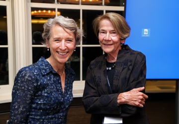 Blonde woman and brown haired woman smiling 