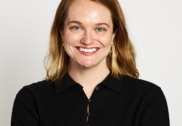 Smiling blonde white woman in black shirt 