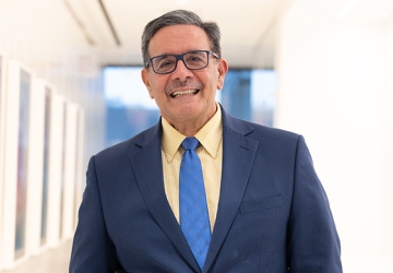 Man with glasses in blue suit and blue tie