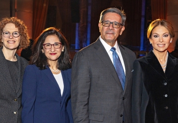 Three women and one man in business attire