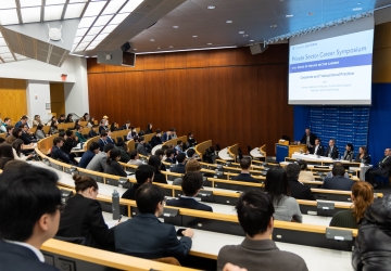 Full classroom of students listening to panel discussion