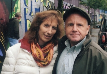 Woman in colorful scarf with man in cap