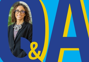 Graphic Q&A with inserted photo of smiling dark haired woman with glasses. 
