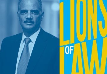 Man in tie next to Lions of Law logo