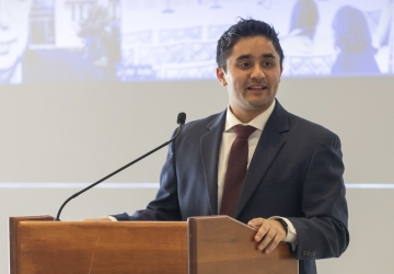 Shaunak Puri standing at podium