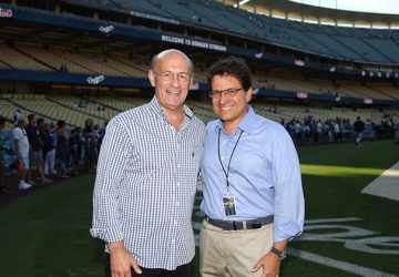 Stan Kasten and Mark Attanasio stand in Dodger Stadium.