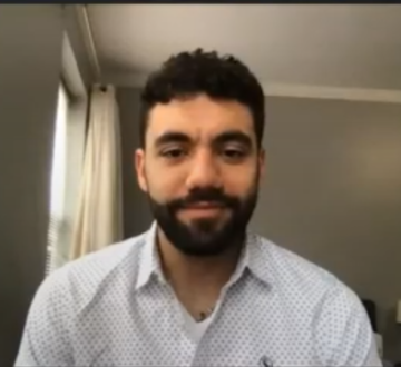 Mo’taz Arshied in front of his computer at home