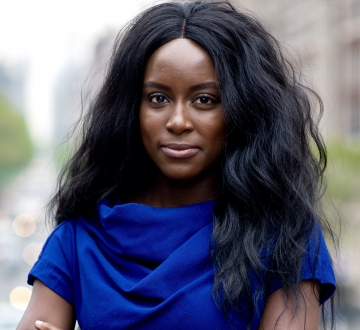 Columbia Law Review Editor in Chief Oluwatumise Asebiomo in blue dress