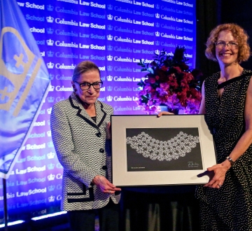 Dean Gillian Lester presents Ruth Bader Ginsburg with a custom made lace collar.