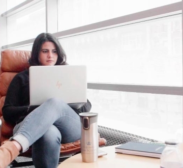 Amanda Soto Fontes ’18 LL.M. studies on a laptop in Jerome Greene Hall.