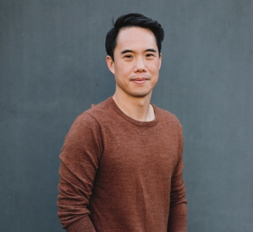 Dark-haired man in brown sweater