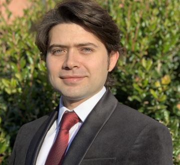 Dark-haired man in suit and tie