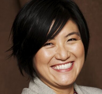 Dark-haired woman in gray jacket