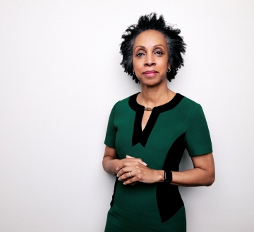 Portrait of Nina Shaw wearing a green and black dress
