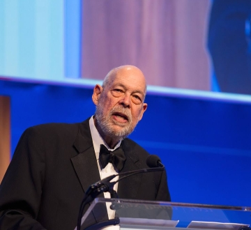 Michael J. Graetz speaking at a podium