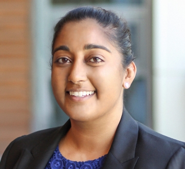 Woman in a blue blouse and black blazer