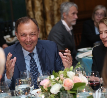 Man in a suit at a dinner event 