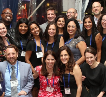 A group of about 20 people posing together