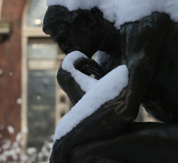 Thinker sculpture with snow