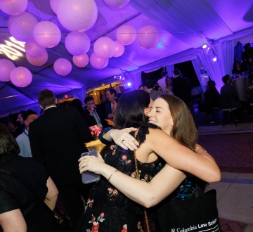 Women hugging in party tent