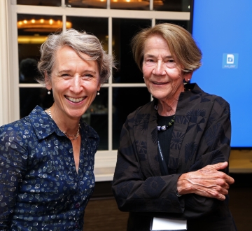Blonde woman and brown haired woman smiling 