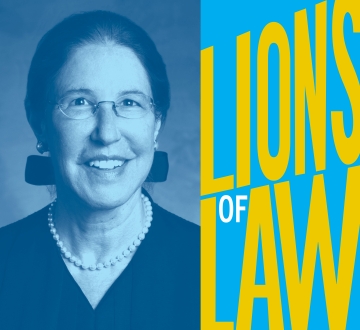 Woman in judge's robe and pearls with Lions of Law text 