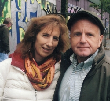 Woman in colorful scarf with man in cap