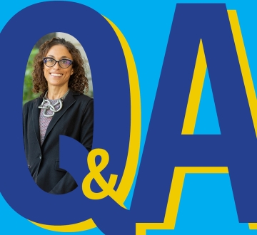 Graphic Q&A with inserted photo of smiling dark haired woman with glasses. 