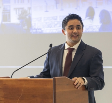 Shaunak Puri standing at podium