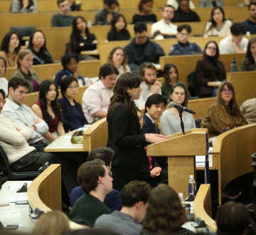 A speaker at a podium in a classroom