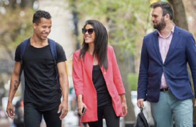 Three people walking in a row