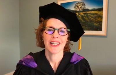 Gillian Lester wears academic regalia in her home as she addresses the class of 2020 for remote graduation ceremonies.