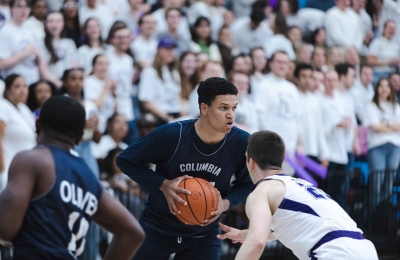 A Columbia Law student holds a basketball.