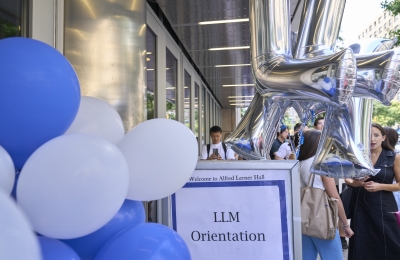 balloons and sign reading "LLM Orientation"