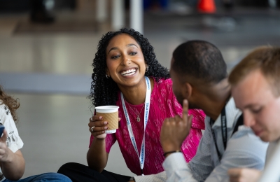 Smiling woman student with coffee 