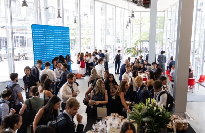Crowd of students mingling over breakfast 