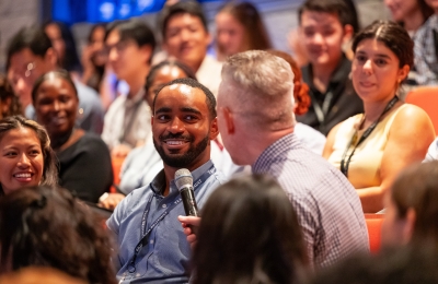 Male student speaking into microphone during orientation